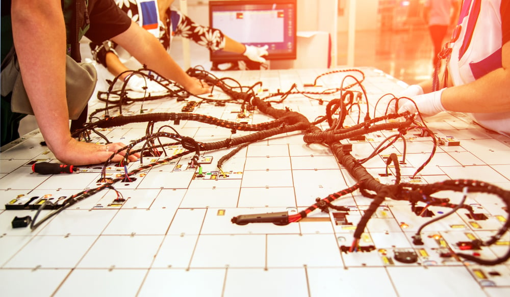 employees who check the quality of the wiring for cars at a factory in Mexico