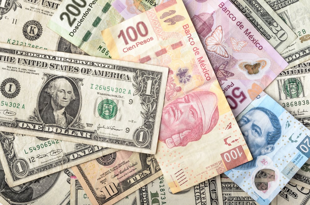 Dollars and Mexican Pesos assorted bills symbolizing gap in wages in Mexico vs. USA